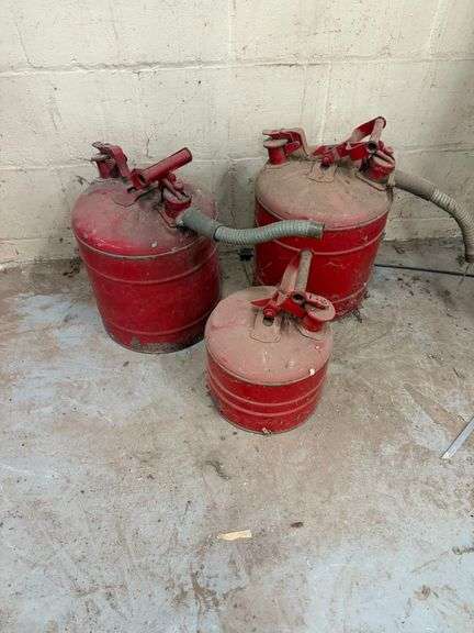 Three Red Metal Gas Cans image
