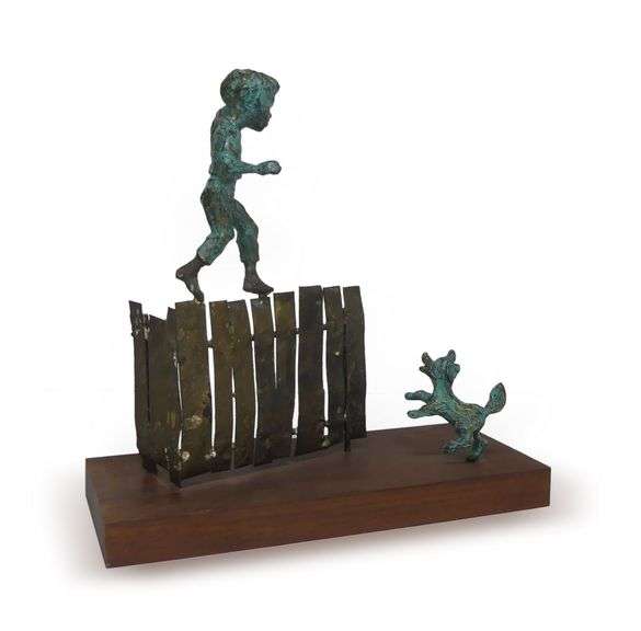 Bronze Sculpture of Boy Walking on Fence image