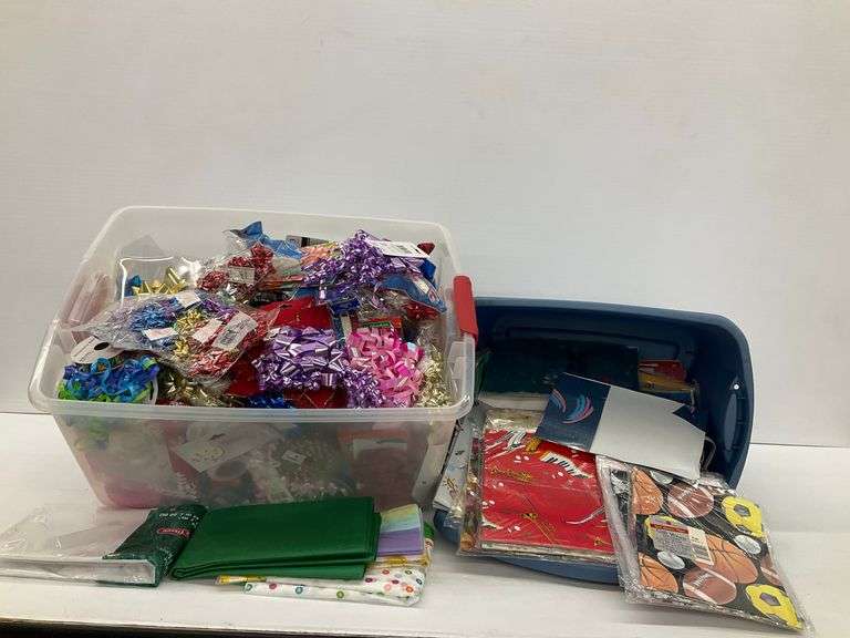 Storage Tubs Filled with Gift Wrapping Supplies: Bows, Ribbon, and Paper image