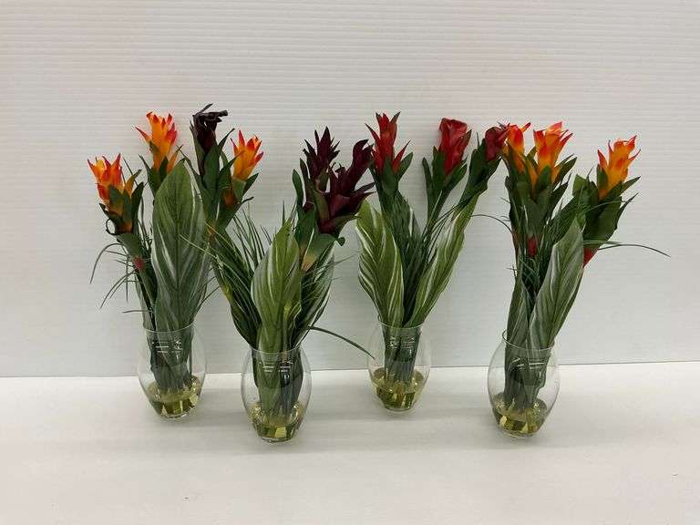 Four Decorative Floral Arrangements in Glass Vases image