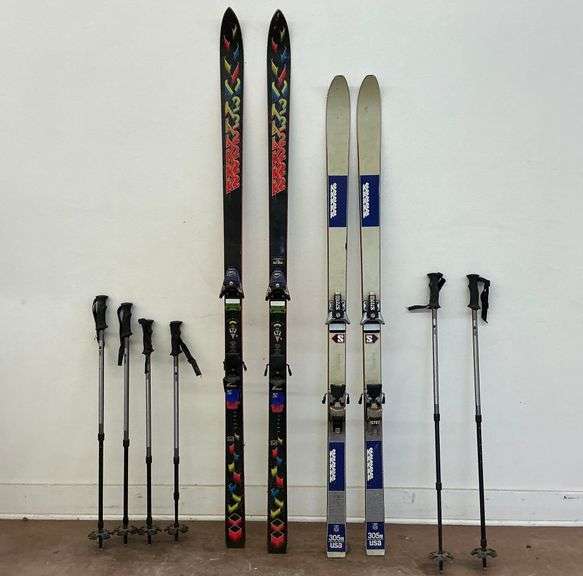 Two Pairs of Downhill Skis and Six Ski Poles image