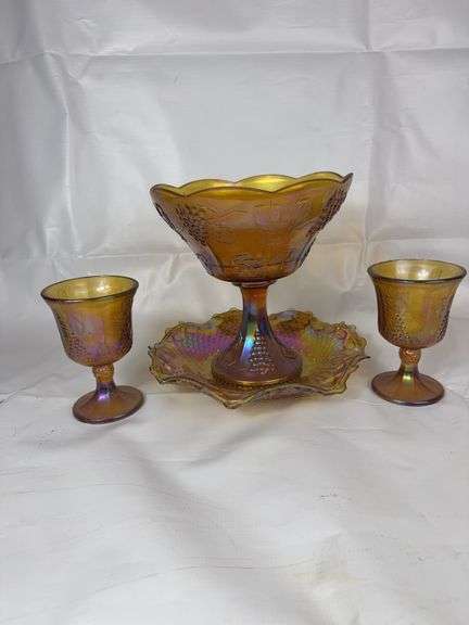 Orange carnival glass punch bowl, goblets and dish.
