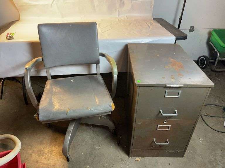 Old metal office chair and metal filing cabinet image