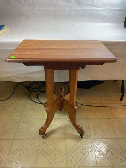 Antique Victorian walnut parlor table with casters image