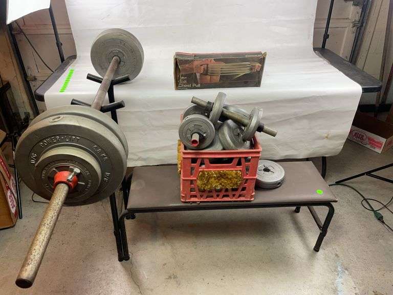 Weight bench with multiple weights and vintage chest puller image