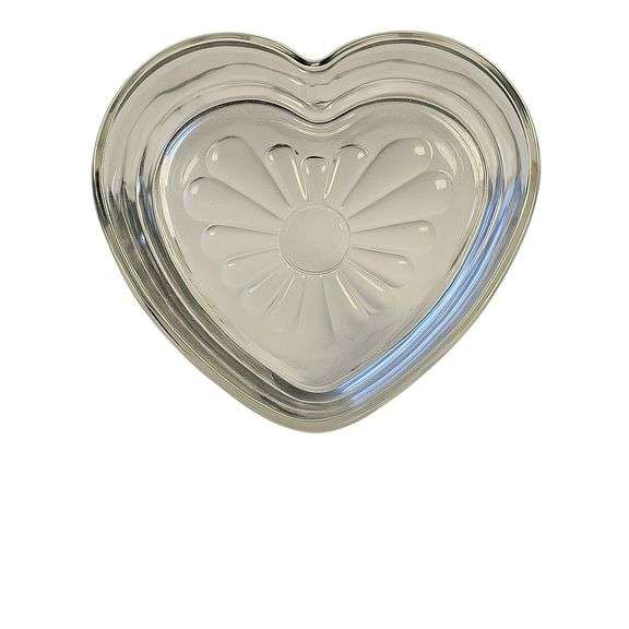 Vintage Heart-Shaped Glass Dish Charming clear glass dish in a heart shape with a pressed flower design at the base. Perfect for use as a trinket holder, candy dish, or decorative accent. The glass has a nice clarity and smooth finish, adding a touch of vintage elegance to any setting. Measures approximately [insert dimensions if known]. In very good preowned condition with light signs of use. image