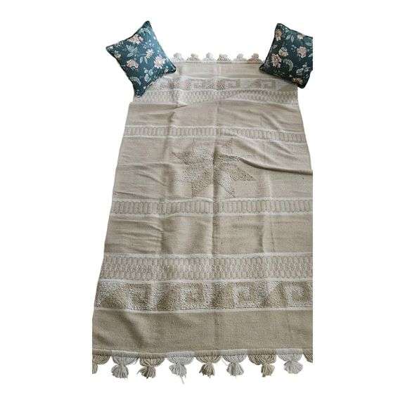 Neutral Woven Throw Rug with Floral Throw Pillows image