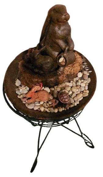 Bunny Statue on Green Metal Stand image