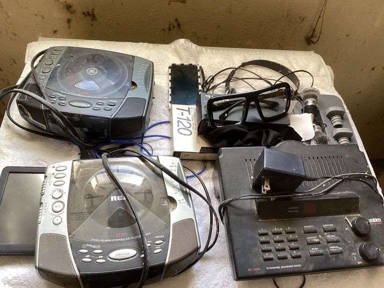 Mixed Lot: GE & RCA CD Clock Radios, Uniden Scanner Radio, Wine Stoppers, Glasses, VHS Tape, and Garmin GPS Unit image