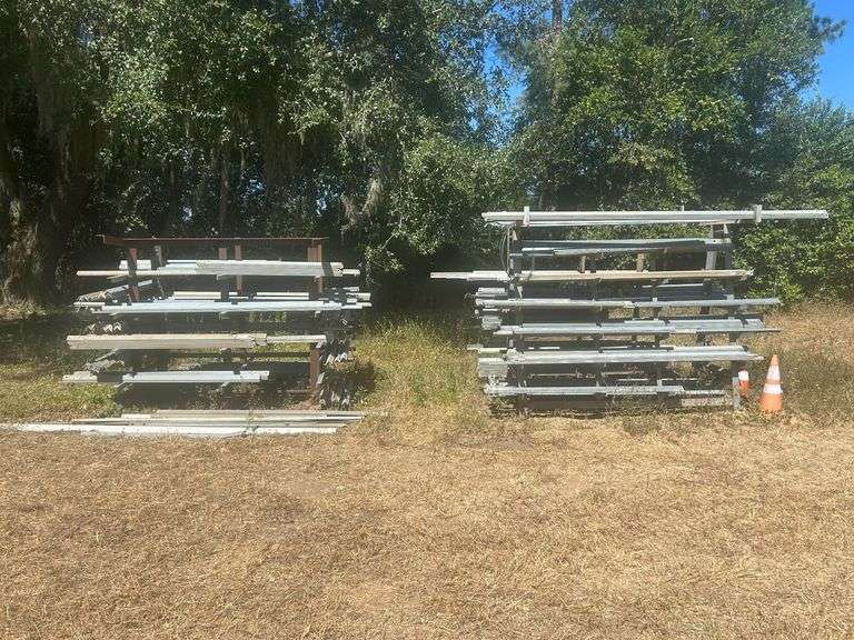 (2) Metal Stands with Contents - Various Sizes & Lengths of Galvanized Angle Iron, & Stacks of Angle Iron Behind Racks image