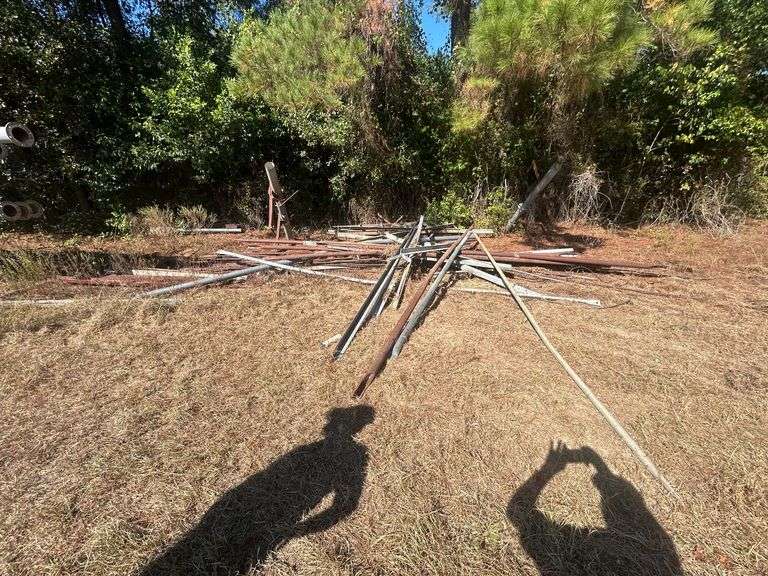 Various Irrigation Parts - Angle Iron, Pipe, Bracing Rods, Hard Hose Reel, Sheet Metal, Red Iron, Red Iron Poles, Fittings, Used Motors, Camper, Used Hoses with Sprinklers & Weights, & Motor image