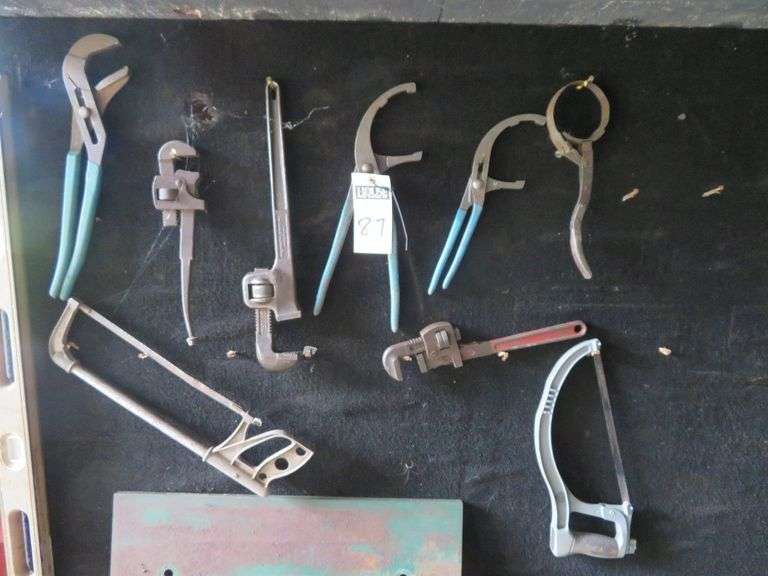 Three pipe wrenches, two clamp plier, one channel lock, two hacksaws, oil filter wrench image