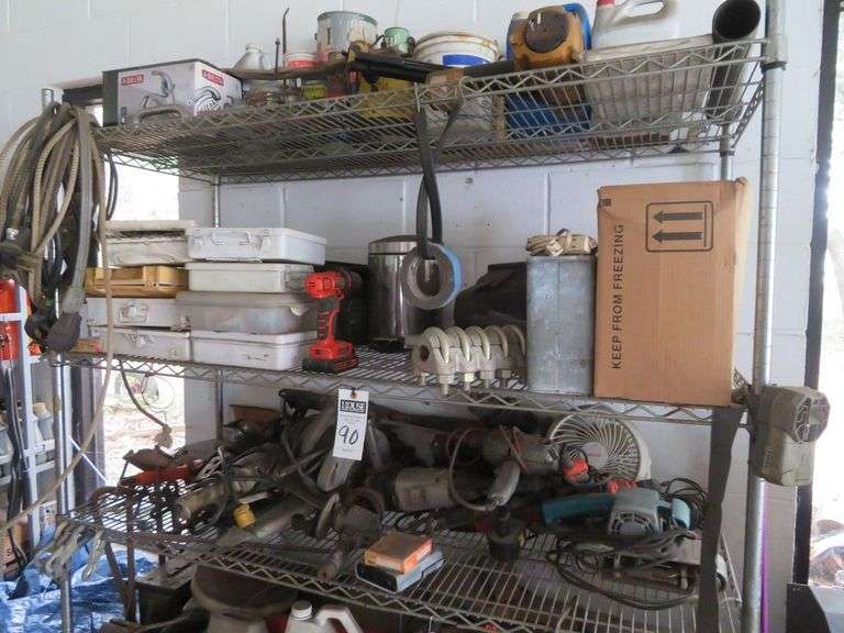 Entire contents of shelf, empty metal boxes (first aid style), ECHO chainsaw, rope, sander, real old tools image