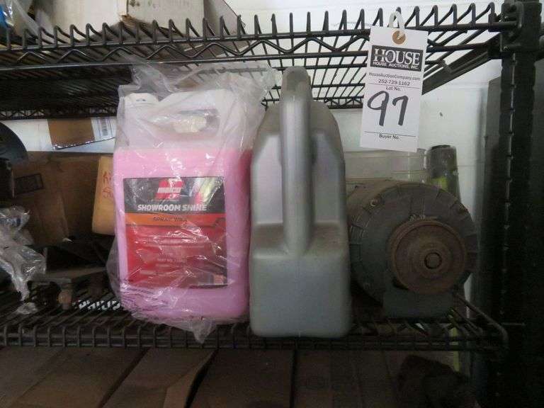 Shelf-mostly full of  assorted automotive fluids - transmission fluid, motor oil, shelf sells with lot image