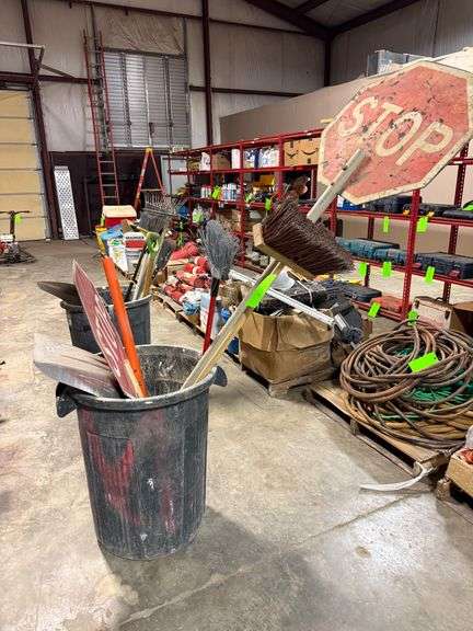 Trash Bin with Brooms and Signs image