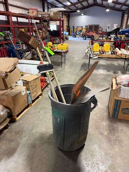 Trash Bin with Brooms and Signs image