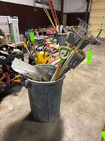 Trash Bin with Shovels, Rake, Post Hole Digger, etc image