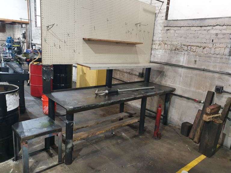 Work Bench with pegboard, Shop-made stool, hand pump and cylinder image