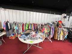 Large Lot:  ALL clothes/ALL shoes, (2) rolling clothes racks and table