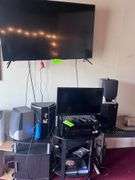 (3) tables with electronic Equipment: (2) TV, receiver, (4) speakers