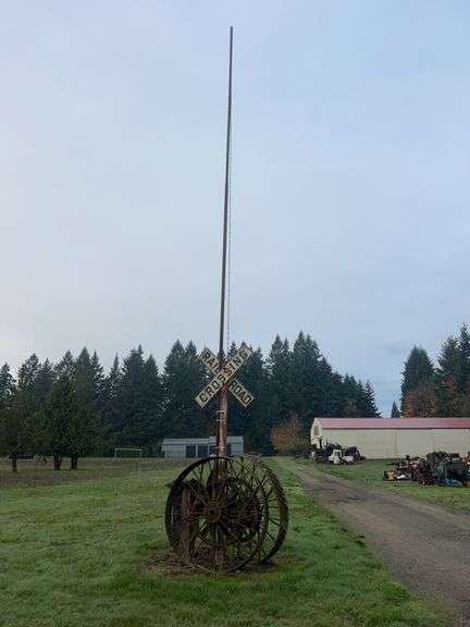 Wheels, Railroad Crossing Sign, and Flag Pole image