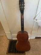 Books, Floor Lamp, and Old Guitar