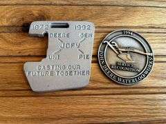 (2) John Deere Medallions