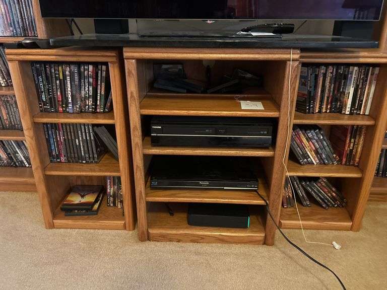 TV stand with Toshiba DVD/VCR player, panasonic blu-ray player, and DVDs image