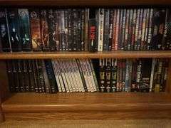 Bookshelf and DVD’s, Small Boombox -  (assorted DVD's)  The shelf is 82” tall by 36” wide.