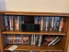 Bookshelf and DVD’s, Small Boombox -  (assorted DVD's)  The shelf is 82” tall by 36” wide.