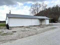 TRACT #1 (12010 Main St SW, Mauckport, IN): 0.325 ac corner lot with 1326 SF former postal building.
