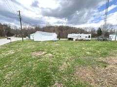 TRACT #1 (12010 Main St SW, Mauckport, IN): 0.325 ac corner lot with 1326 SF former postal building.