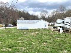 TRACT #1 (12010 Main St SW, Mauckport, IN): 0.325 ac corner lot with 1326 SF former postal building.