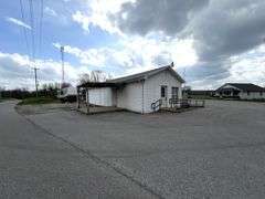 TRACT #1 (12010 Main St SW, Mauckport, IN): 0.325 ac corner lot with 1326 SF former postal building.