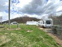 TRACT #1 (12010 Main St SW, Mauckport, IN): 0.325 ac corner lot with 1326 SF former postal building.