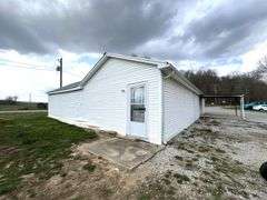 TRACT #1 (12010 Main St SW, Mauckport, IN): 0.325 ac corner lot with 1326 SF former postal building.