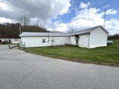 TRACT #1 (12010 Main St SW, Mauckport, IN): 0.325 ac corner lot with 1326 SF former postal building.
