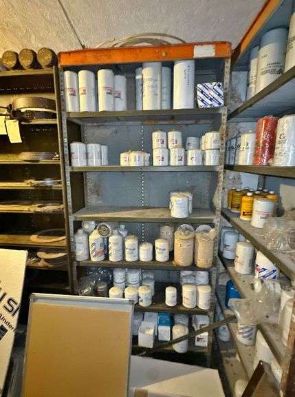 New & Used Tractor Parts with Metal Shelving image