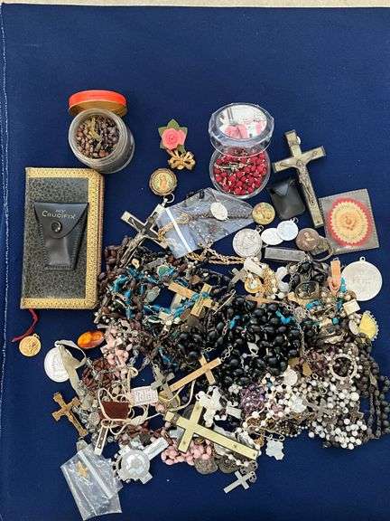 Religious related jewelry; lots of rosaries, pendants image