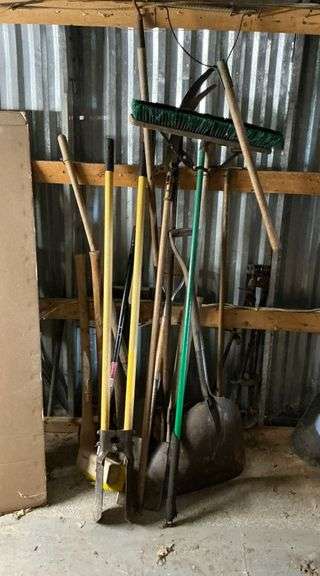 Long handled tools, weed whacker, brooms, post hole digger, limb saws image