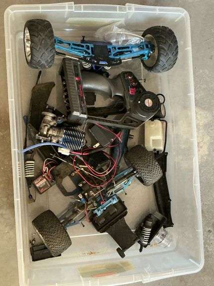 Parts of Traxxas 4-wheel drive RC car with engine, radio receiver image
