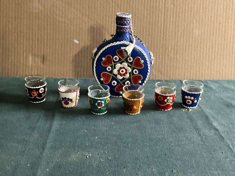 Leather covered flask and shot glasses. image