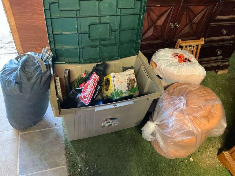 Camping supplies, sleeping bags, tent, hatchet, shovel image