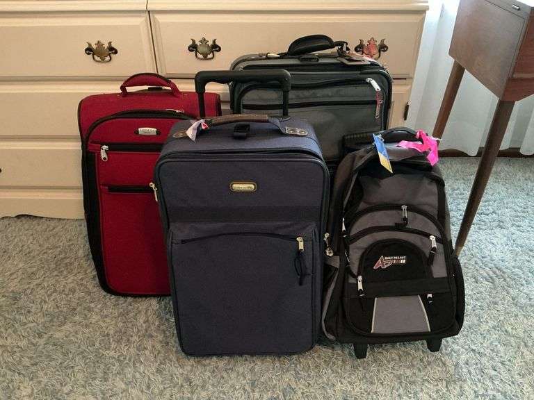 3 Rolling suitcases, rolling backpack. image