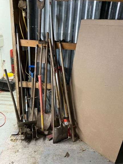 Long handled tools, shovels, pick axe, sledge hammer, pitch fork image