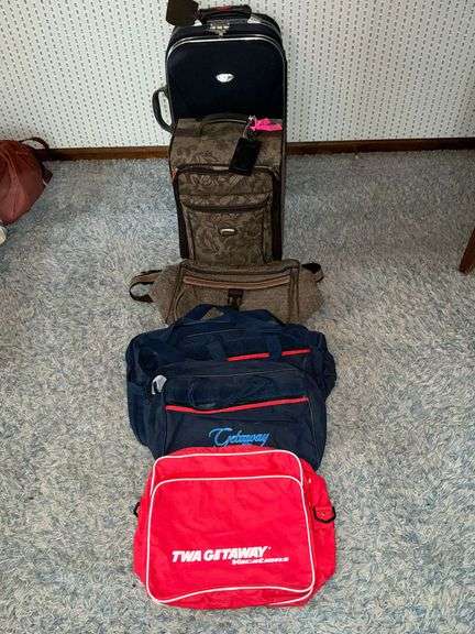 2 rolling suitcases and duffle bags image