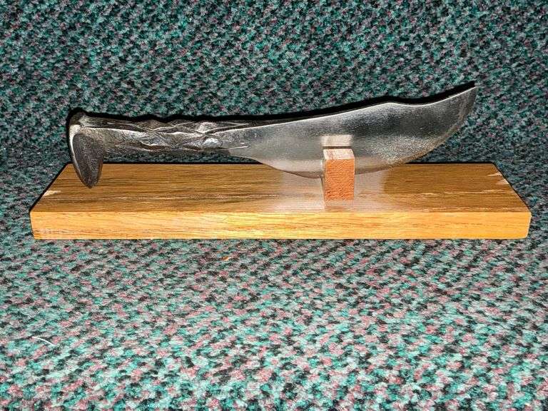 Knife handcrafted from a railroad spike on wooden stand image