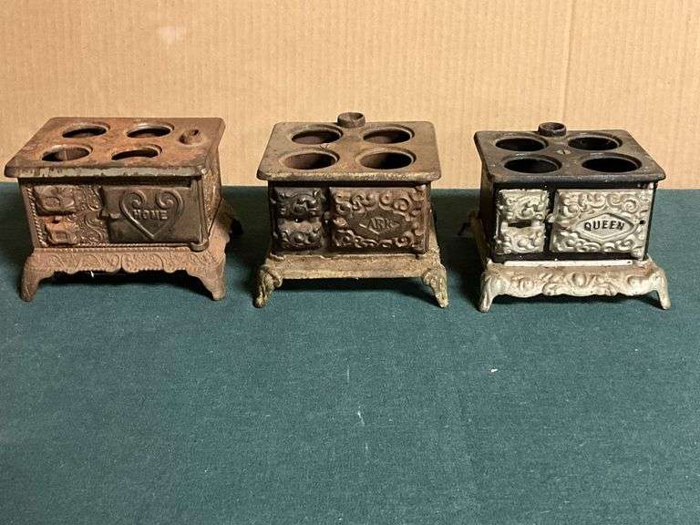 Pair of Queen cast iron mini stoves, and other, missing accessories. image