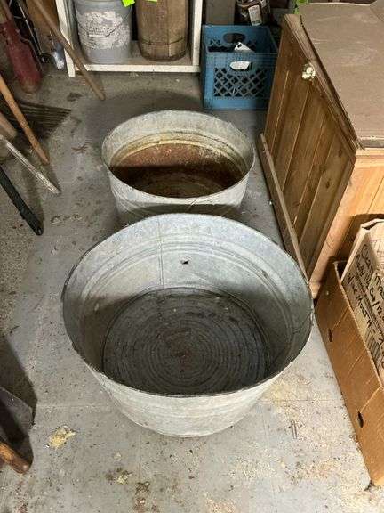 2 galvanized tubs, holes. image