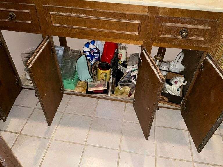 Contents of vanity, curling irons, cleaning supplies, curlers, soap dish image